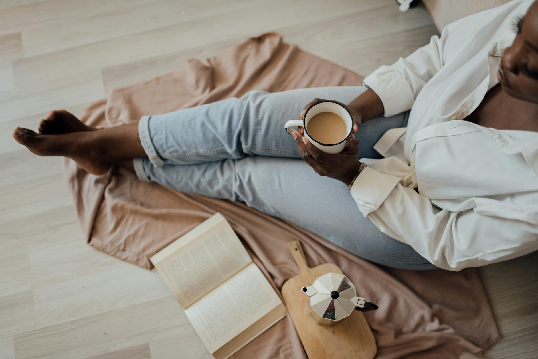 a woman having a cup of coffee