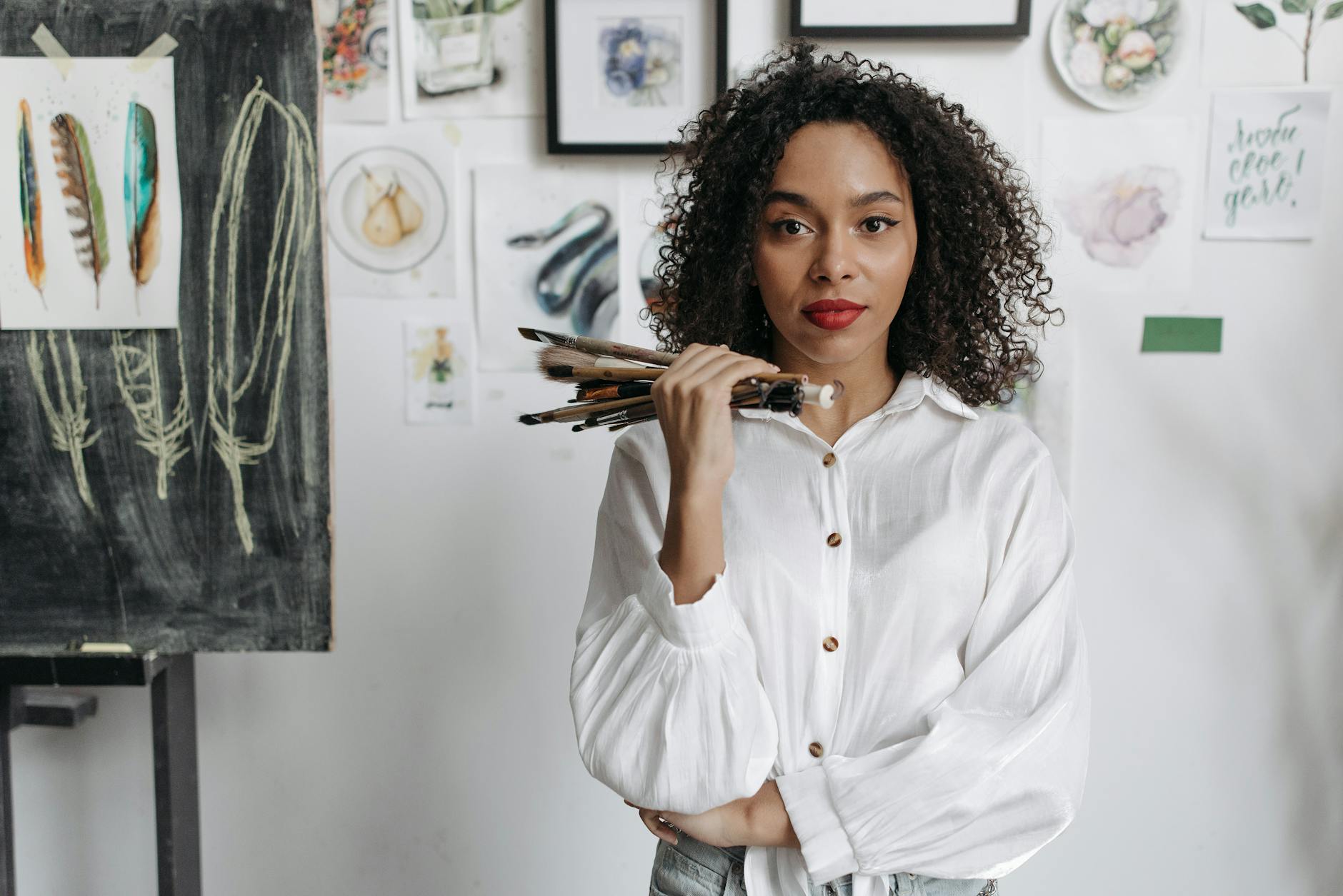 woman in white dress shirt holding brown and black smartphone